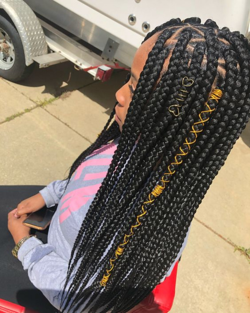 box braids adorned with silver, jewels, and string