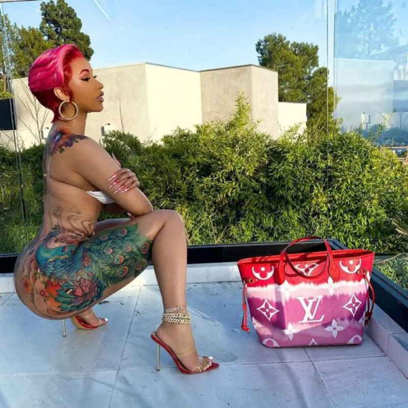 cardi b peacock tattoo, tattoo artist, cardi b