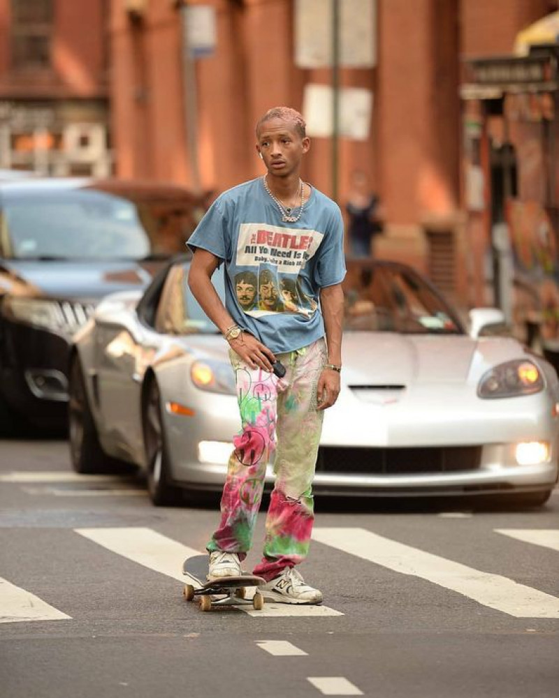 sports equipment, jaden smith, light blue t-shirt, beach pant, multicolor sandal, beige trainer