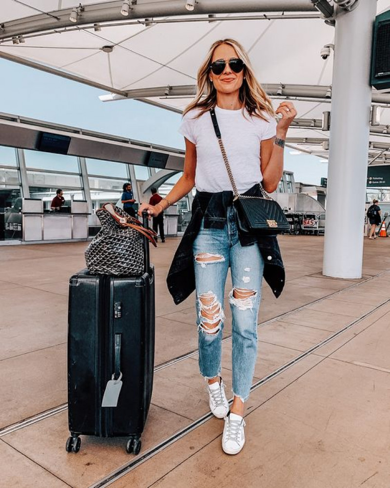 best airport outfits 2023, luggage and bags, airport fashion, air travel, road trip, light blue casual trouser, white t-shirt, white sneaker, black formal shoe