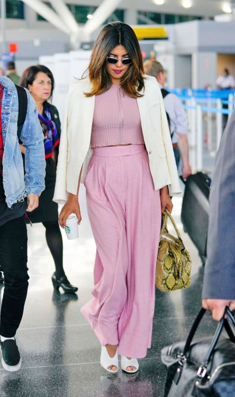 celebrities airport outfits, john f. kennedy international airport, luggage and bags, celebrity style, priyanka chopra, nick jonas, gigi hadid, pink suit jackets and tuxedo, pink casual trouser, pink vest, black elegant boot chelsea and ankle boot, black elegant boot free time shoe, white sandal
