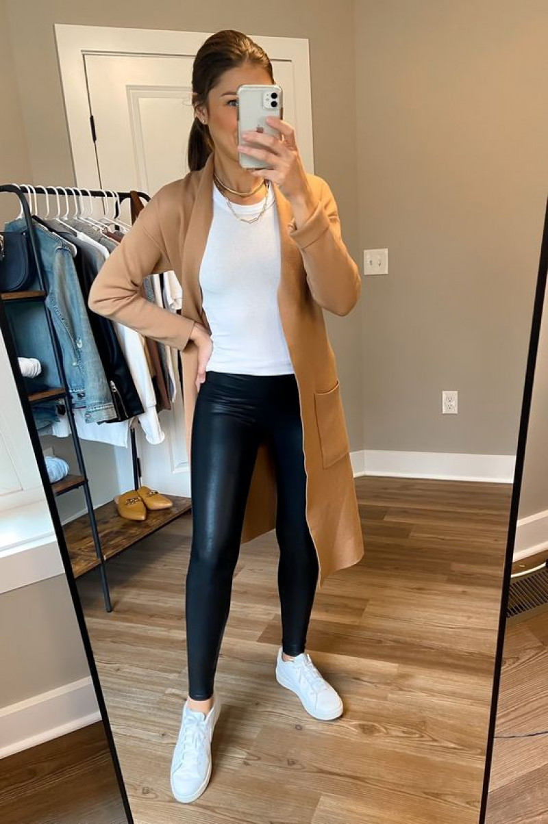 best tops to wear with leather leggings, beige trench coat, blue leather legging, white sneaker