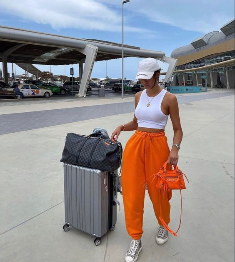 comfy airport outfits summer, waste containment, airport fashion, waste container, vacation ideas, orange sweat pant, white crop top, grey sneaker